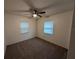 Bedroom featuring neutral walls, carpet flooring, and natural light from two windows at 11308 Echo View Dr, Odessa, FL 33556