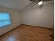 An additional bedroom features updated wood floors and a large window at 11308 Echo View Dr, Odessa, FL 33556