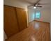 Bedroom with wood flooring and a closet with sliding wooden doors at 11308 Echo View Dr, Odessa, FL 33556
