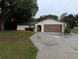 Neutral stucco single story home featuring a large driveway and an attached two car garage at 11308 Echo View Dr, Odessa, FL 33556