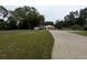 Single story home featuring a large front yard and a long concrete driveway to the attached two car garage at 11308 Echo View Dr, Odessa, FL 33556