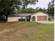 Charming single-story home with a well-maintained lawn, stucco exterior, and attached garage, offering comfort and convenience at 11308 Echo View Dr, Odessa, FL 33556