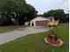 Inviting home with a well-maintained driveway, lush lawn, and charming wishing well feature, creating a welcoming ambiance at 11308 Echo View Dr, Odessa, FL 33556