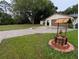 A home with a spacious front lawn, a wishing well, and an attached two-car garage at 11308 Echo View Dr, Odessa, FL 33556