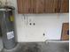 Garage view featuring water heater, mounted storage and other utilities at 11308 Echo View Dr, Odessa, FL 33556