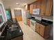 Kitchen featuring tile floor, wood cabinets, granite counters and white appliances at 11308 Echo View Dr, Odessa, FL 33556