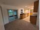 Bright kitchen leads to patio, showcasing black granite counters, wooden cabinets, and modern appliances at 11308 Echo View Dr, Odessa, FL 33556