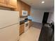 Kitchen featuring oak cabinets, black granite countertops and tile floors at 11308 Echo View Dr, Odessa, FL 33556