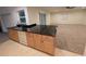 Kitchen view showcasing oak cabinets, granite countertops and an adjoining living room at 11308 Echo View Dr, Odessa, FL 33556