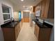 Open kitchen includes sleek granite counters, wood cabinets, white appliances, and tile flooring at 11308 Echo View Dr, Odessa, FL 33556