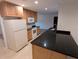 Kitchen featuring granite countertops, white appliances, and wooden cabinets at 11308 Echo View Dr, Odessa, FL 33556