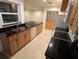 Bright kitchen featuring granite countertops, tile flooring, and wooden cabinets at 11308 Echo View Dr, Odessa, FL 33556