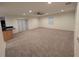 Spacious living room with carpet flooring and access to the kitchen at 11308 Echo View Dr, Odessa, FL 33556
