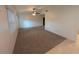 Spacious living room with neutral carpeting and a ceiling fan for added comfort at 11308 Echo View Dr, Odessa, FL 33556