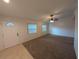 Open living area with tile entryway, carpet, natural light, and a ceiling fan at 11308 Echo View Dr, Odessa, FL 33556