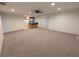 Spacious living room with carpet flooring and open concept access to the kitchen at 11308 Echo View Dr, Odessa, FL 33556