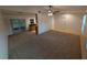 Open concept living room featuring neutral paint, carpet and a ceiling fan with a view of the kitchen at 11308 Echo View Dr, Odessa, FL 33556