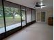 Relaxing covered patio with ceiling fan, wet bar, and screened enclosure offers picturesque backyard views and versatile living space at 11308 Echo View Dr, Odessa, FL 33556