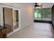 Tranquil covered patio has ceiling fan, wet bar, and screened enclosure provides a comfortable transition between indoor and outdoor living at 11308 Echo View Dr, Odessa, FL 33556