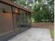 Inviting screened patio with a ceiling fan, offering a comfortable and private outdoor space for relaxation and entertainment at 11308 Echo View Dr, Odessa, FL 33556