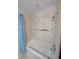 Updated shower tub with a clean white finish and attractive marble-look shower surround at 11308 Echo View Dr, Odessa, FL 33556
