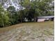 A view of the large and partially wooded yard with the home to the right at 11308 Echo View Dr, Odessa, FL 33556