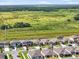 Aerial view of a neighborhood backing up to an expansive grassy plain at 11745 Brighton Knoll Loop, Riverview, FL 33579