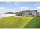 Well-maintained backyard features a spacious lawn and a covered patio for outdoor enjoyment at 11745 Brighton Knoll Loop, Riverview, FL 33579