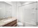 Bright bathroom featuring a granite countertop, shower over bath, and modern fixtures at 11745 Brighton Knoll Loop, Riverview, FL 33579
