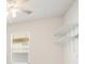 Bedroom with a ceiling fan, window, and shelving unit on the wall at 11745 Brighton Knoll Loop, Riverview, FL 33579