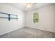 Bedroom with a window, carpeted flooring, ceiling fan and built-in blue shelving unit at 11745 Brighton Knoll Loop, Riverview, FL 33579