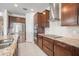 Stylish kitchen featuring granite countertops, stainless steel appliances, and dark wood cabinetry at 11745 Brighton Knoll Loop, Riverview, FL 33579