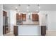 Modern kitchen with stainless steel appliances, granite countertops, and an island with a sink at 11745 Brighton Knoll Loop, Riverview, FL 33579