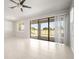Spacious living area featuring tile flooring and sliding glass doors to the outdoor living space at 11745 Brighton Knoll Loop, Riverview, FL 33579