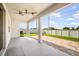 Spacious covered patio features a ceiling fan and a view of the landscaped backyard at 11745 Brighton Knoll Loop, Riverview, FL 33579