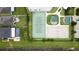 Aerial view of community tennis courts, basketball court, and pool with backyard at 11926 Grand Kempston Dr, Gibsonton, FL 33534
