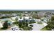 Aerial view of community pool, clubhouse, playground, and parking spaces surrounded by greenery at 11926 Grand Kempston Dr, Gibsonton, FL 33534