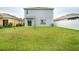 Expansive backyard featuring green grass, new privacy fence and an outdoor AC unit at 11926 Grand Kempston Dr, Gibsonton, FL 33534