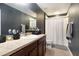 Bathroom features a single sink vanity, and a shower with a curtain at 11926 Grand Kempston Dr, Gibsonton, FL 33534
