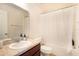 Bathroom featuring a sink, toilet, and shower with a curtain at 11926 Grand Kempston Dr, Gibsonton, FL 33534