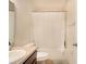 Bathroom featuring a sink, toilet, and shower with a curtain at 11926 Grand Kempston Dr, Gibsonton, FL 33534
