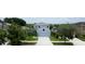 Two-story light-blue home with a gray roof, a two-car garage and a well-manicured lawn at 11926 Grand Kempston Dr, Gibsonton, FL 33534