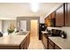 Well-lit kitchen featuring stainless steel appliances and a spacious breakfast bar with counter tops at 11926 Grand Kempston Dr, Gibsonton, FL 33534