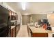Spacious kitchen with modern appliances and island featuring double sink and generous counter space at 11926 Grand Kempston Dr, Gibsonton, FL 33534