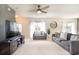 Comfortable living room with neutral tones, plush seating, a ceiling fan, and natural light at 11926 Grand Kempston Dr, Gibsonton, FL 33534