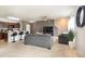 Open-concept living area with kitchen and bar seating, modern decor, and lots of natural light at 11926 Grand Kempston Dr, Gibsonton, FL 33534