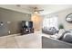 Inviting living room with plush seating, a ceiling fan, and natural light from the window at 11926 Grand Kempston Dr, Gibsonton, FL 33534