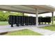 Community mailboxes for residents under a shaded shelter near a grassy area at 11926 Grand Kempston Dr, Gibsonton, FL 33534