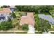 Aerial view of property with a screened-in pool and fenced backyard surrounded by mature trees at 1216 Fox Chapel Dr, Lutz, FL 33549