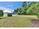 Grassy backyard featuring mixed wooden and vinyl fencing, with mature trees at 1216 Fox Chapel Dr, Lutz, FL 33549